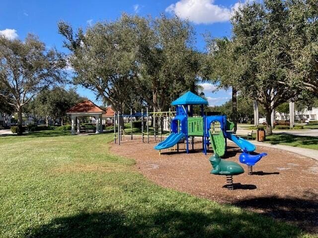 view of playground with a lawn