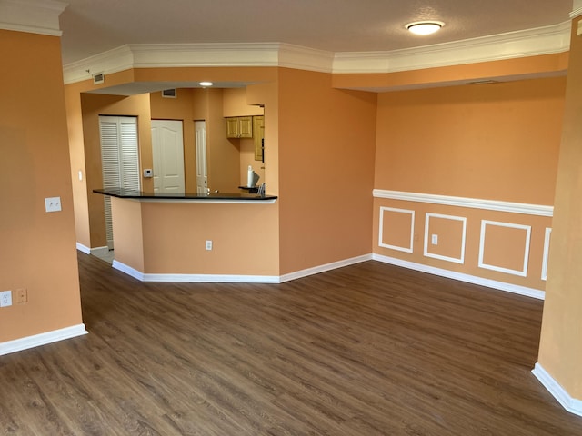 spare room featuring dark hardwood / wood-style floors and ornamental molding