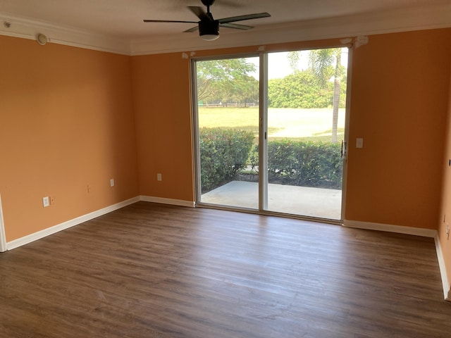 empty room featuring dark hardwood / wood-style flooring, ceiling fan, and crown molding