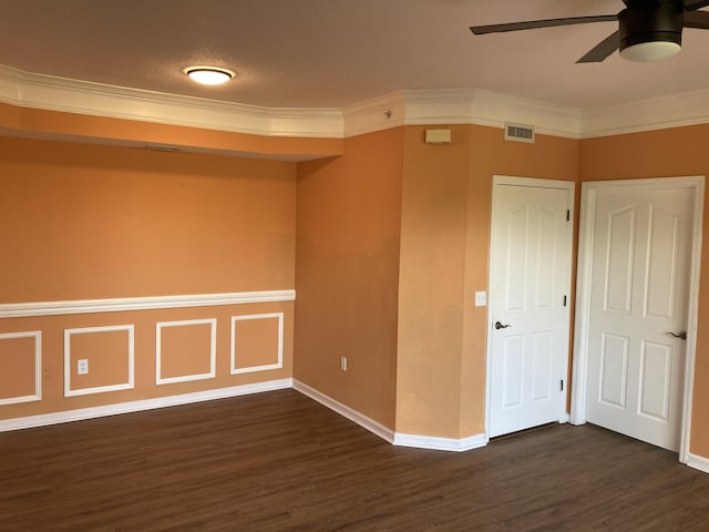 empty room featuring ceiling fan, dark hardwood / wood-style flooring, and ornamental molding