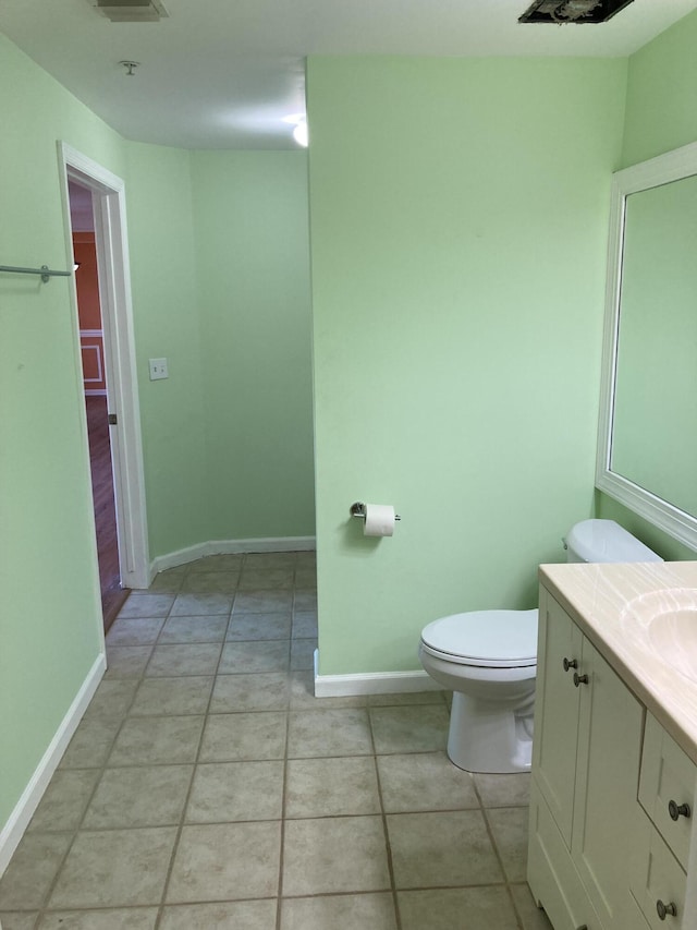 bathroom featuring tile patterned floors, vanity, and toilet