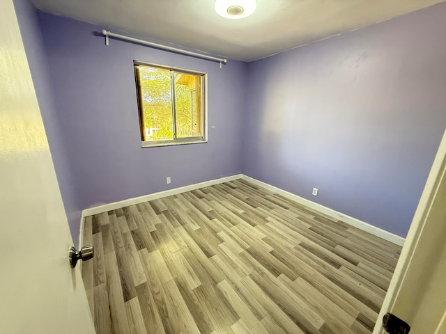 empty room with light hardwood / wood-style floors