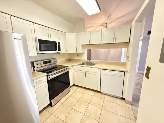 kitchen with white cabinets, sink, lofted ceiling, and stainless steel appliances