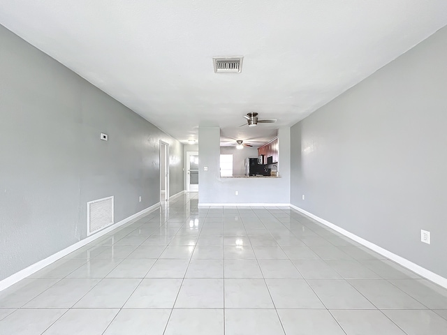 unfurnished living room with ceiling fan and light tile patterned floors