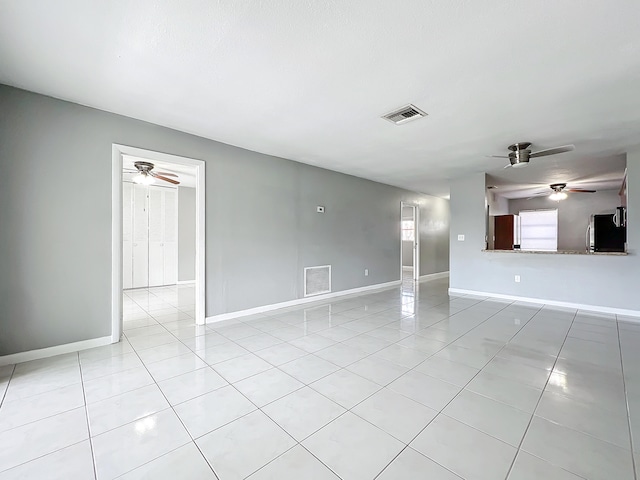 unfurnished living room featuring light tile patterned floors