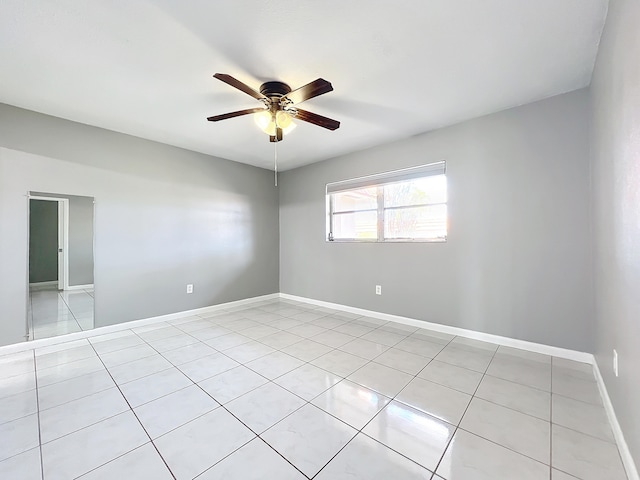 empty room featuring light tile patterned floors and ceiling fan