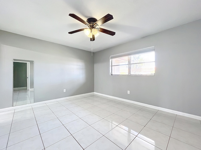 empty room featuring light tile patterned floors and ceiling fan