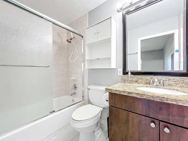 full bathroom featuring shower / bath combination with glass door, tile patterned floors, vanity, and toilet