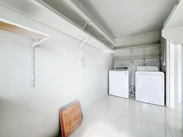 washroom featuring washer and dryer and light tile patterned floors