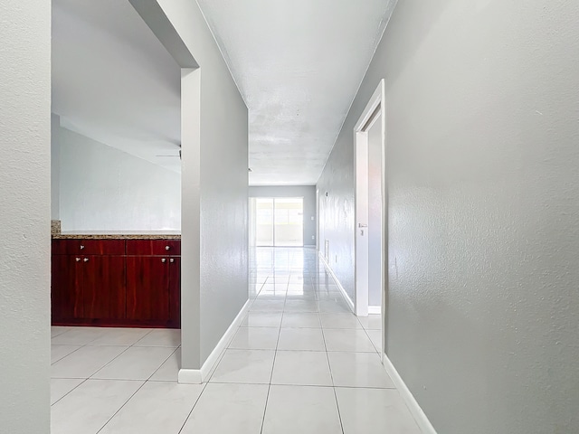 hall featuring light tile patterned flooring