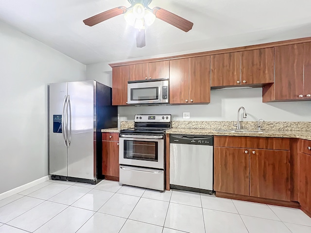 kitchen with ceiling fan, sink, light tile patterned floors, and stainless steel appliances