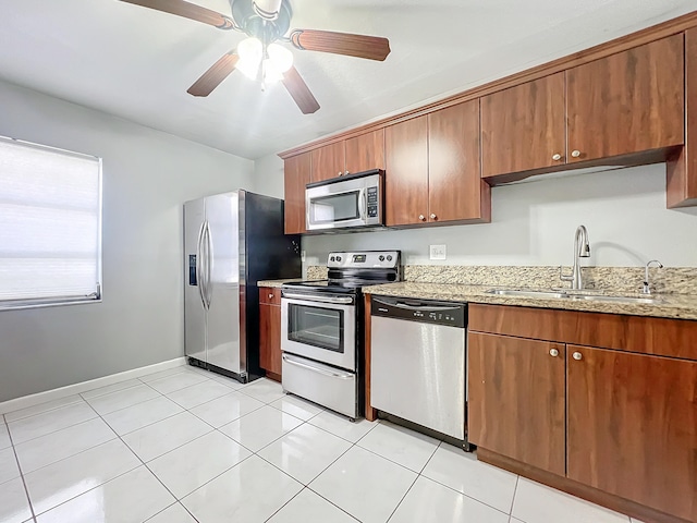 kitchen featuring ceiling fan, sink, light tile patterned flooring, and stainless steel appliances