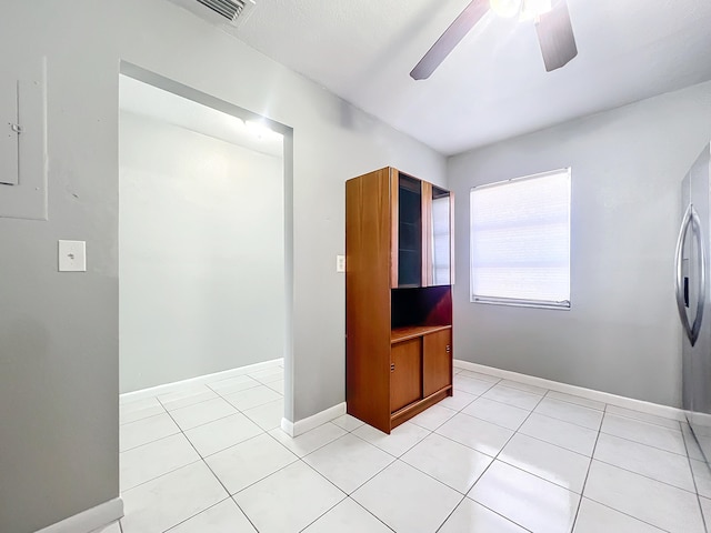 interior space featuring ceiling fan and light tile patterned floors