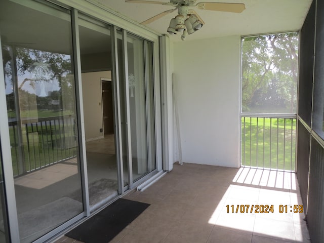 unfurnished sunroom featuring ceiling fan