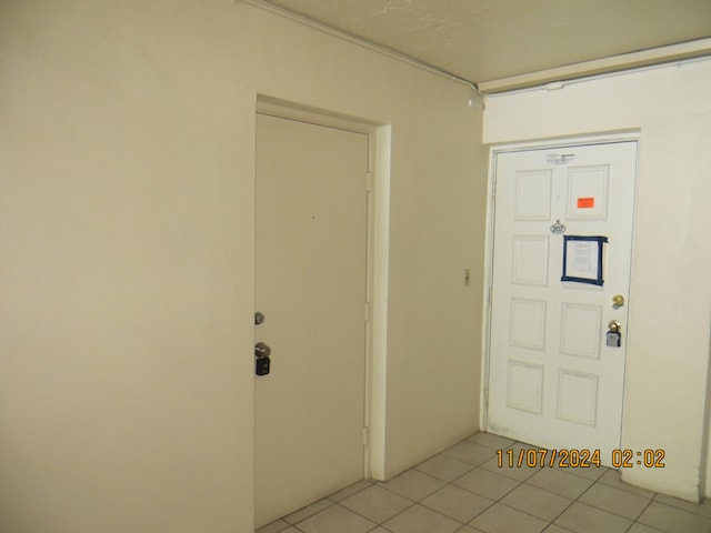 foyer entrance with light tile patterned flooring