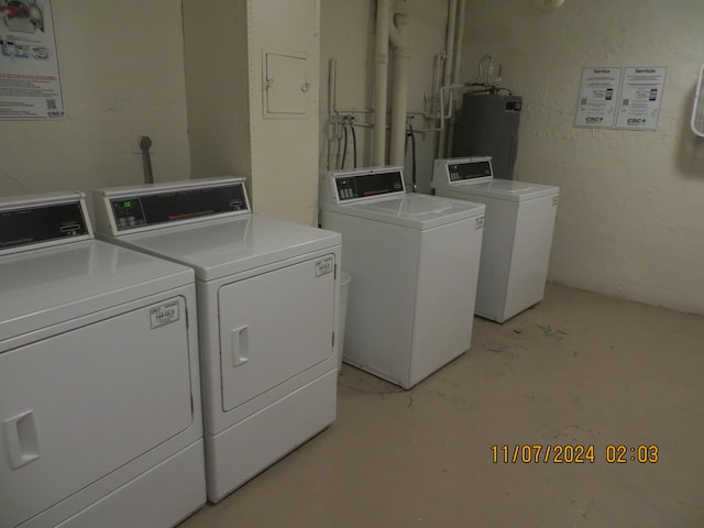 laundry area with washing machine and dryer and water heater