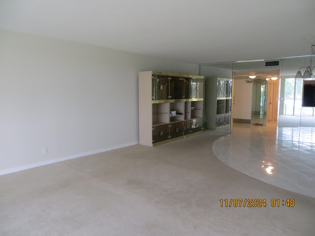 unfurnished living room featuring carpet