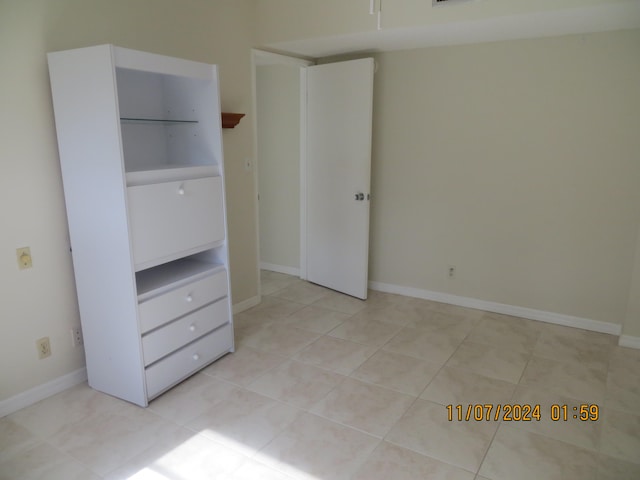 unfurnished bedroom featuring light tile patterned flooring