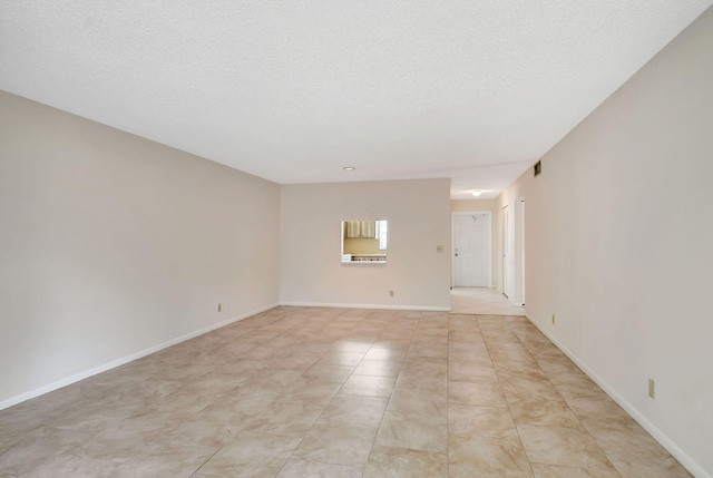 empty room featuring a textured ceiling