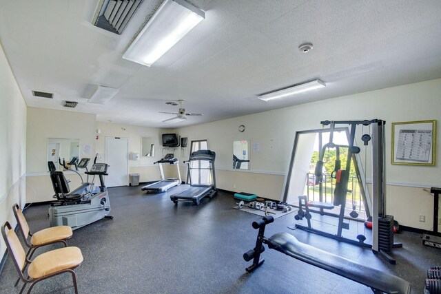 exercise room featuring ceiling fan and a textured ceiling