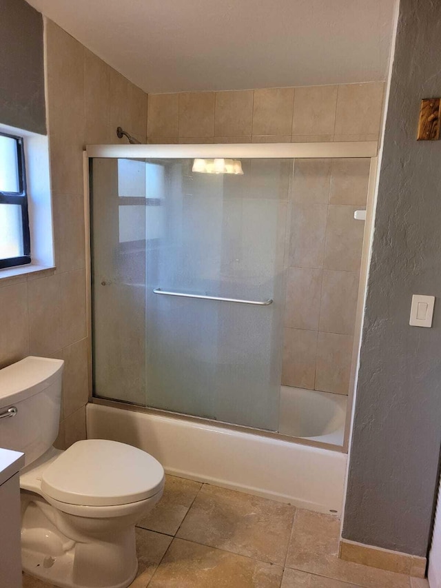 full bathroom with tile patterned floors, vanity, enclosed tub / shower combo, and toilet