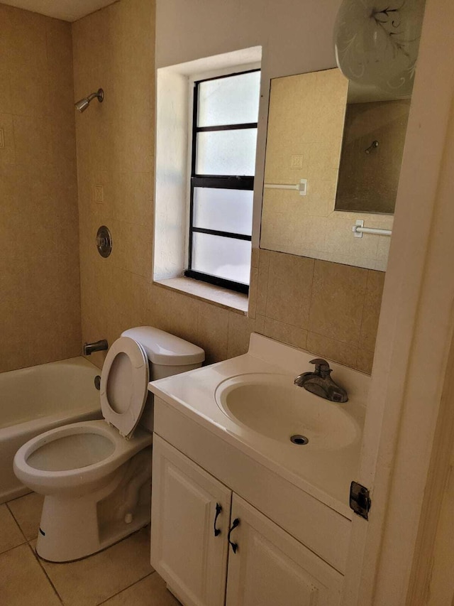 full bathroom featuring vanity, shower / tub combination, tile walls, tile patterned flooring, and toilet