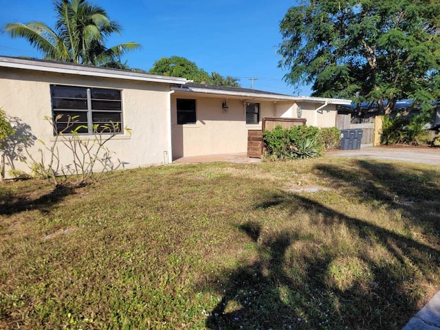 ranch-style home with a front lawn