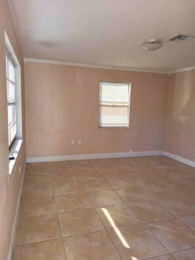 tiled spare room with crown molding