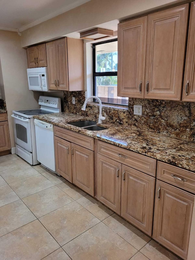 kitchen featuring white appliances, backsplash, sink, dark stone countertops, and light tile patterned floors