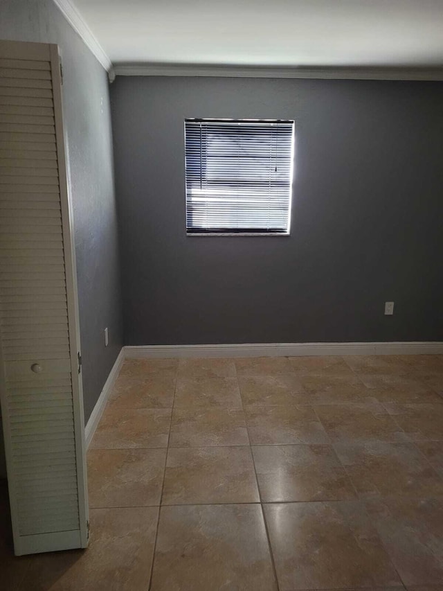 tiled empty room with crown molding