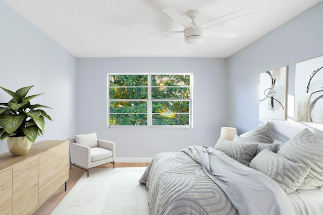 bedroom with wood-type flooring and ceiling fan