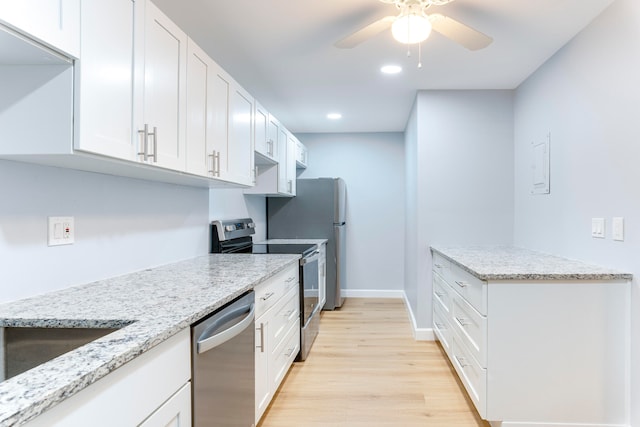 kitchen with white cabinets, ceiling fan, light hardwood / wood-style floors, light stone counters, and stainless steel appliances