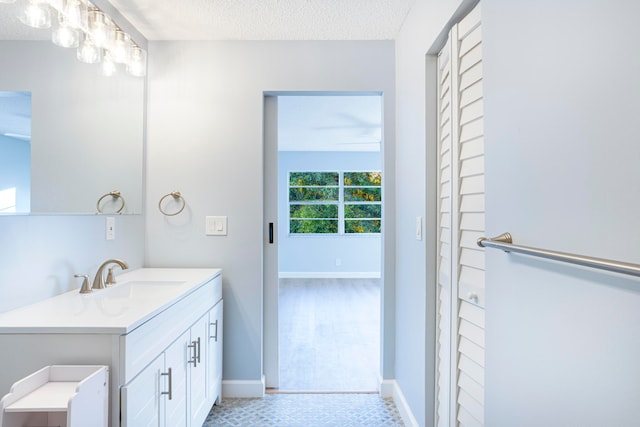 bathroom with vanity and a textured ceiling