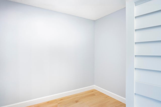 unfurnished room with hardwood / wood-style flooring