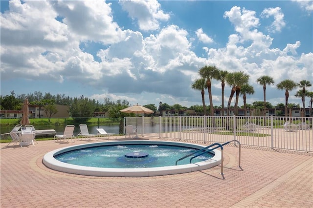 view of swimming pool with a water view