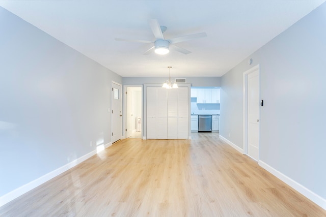 interior space featuring ceiling fan with notable chandelier and light hardwood / wood-style floors