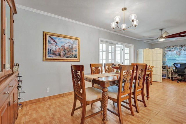 dining space with ceiling fan with notable chandelier, a healthy amount of sunlight, and crown molding