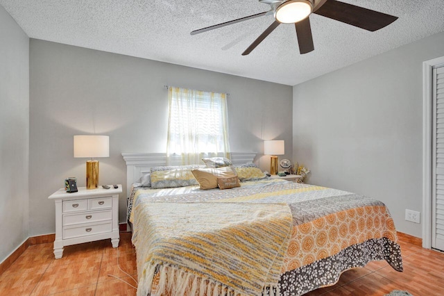 bedroom featuring ceiling fan, a textured ceiling, and light hardwood / wood-style flooring