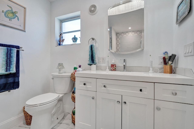 bathroom featuring vanity and toilet