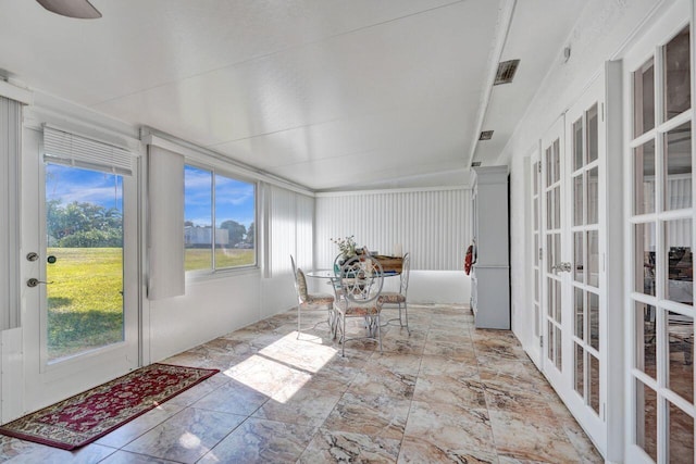 sunroom featuring french doors and vaulted ceiling