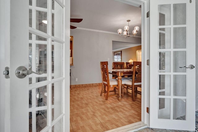 dining area with ceiling fan with notable chandelier and ornamental molding