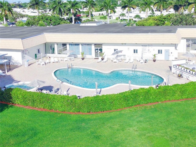 view of swimming pool with a yard and a patio