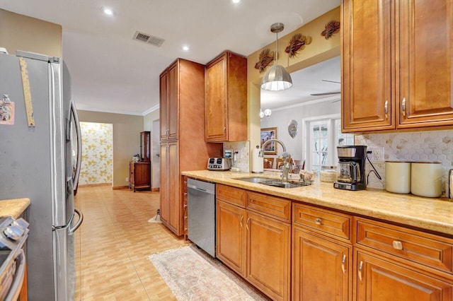 kitchen with appliances with stainless steel finishes, ceiling fan, crown molding, sink, and decorative light fixtures