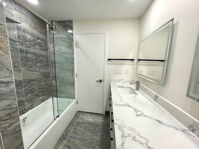 bathroom featuring vanity and bath / shower combo with glass door