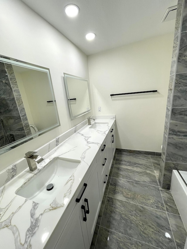 bathroom featuring vanity and a tub to relax in