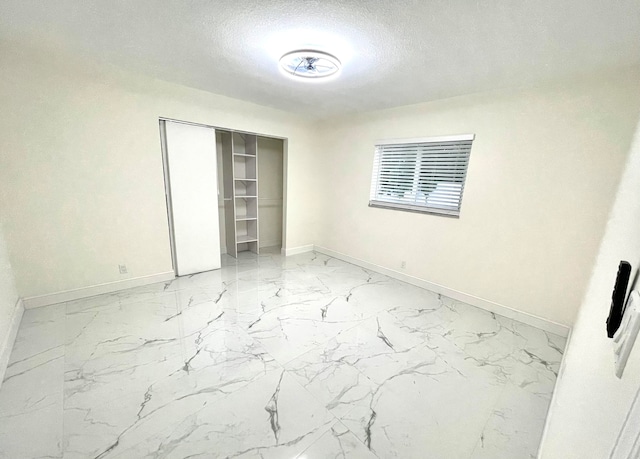 spare room featuring a textured ceiling