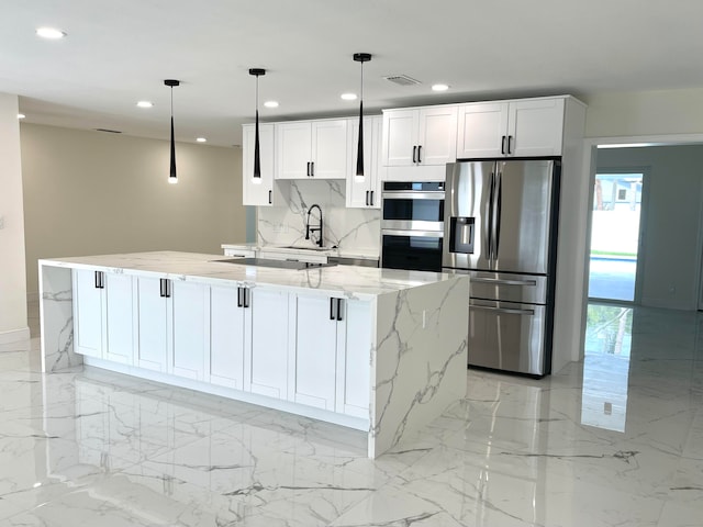 kitchen with white cabinetry, a large island, hanging light fixtures, and appliances with stainless steel finishes