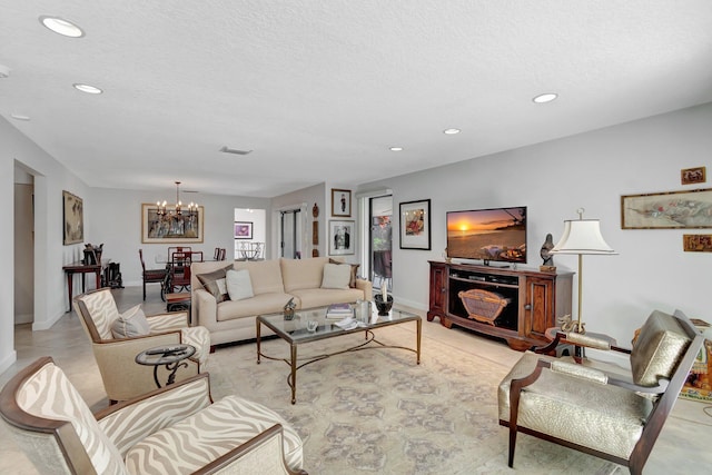 living room featuring a textured ceiling and a chandelier