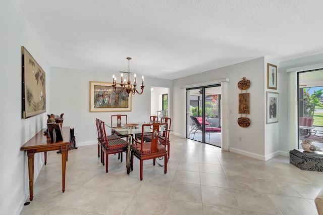 dining room featuring a textured ceiling, an inviting chandelier, and a wealth of natural light