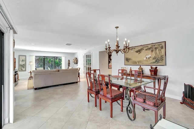 tiled dining area featuring a textured ceiling and a chandelier